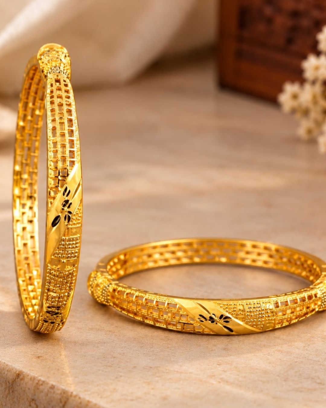 18K gold plated bangles featuring intricate geometric patterns, textured detailing, and black floral accents in an elegant traditional design.