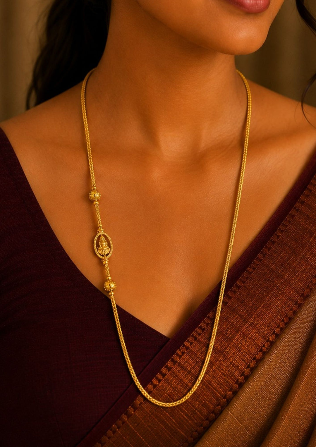 A close-up of a south indian woman wearing a 18K gold plated thalli chain featuring an elegant oval Lakshmi pendant with decorative gold bead accents and premium craftsmanship. ideal for festive and everyday ethnic wear.