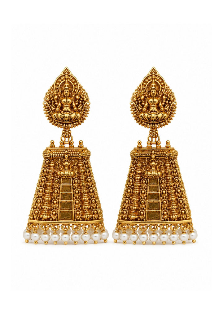 Laxmi Jhumka Gold Plated traditional temple earrings designed with detailed Goddess Laxmi in sitting position on the top portion and large antique style jhumka hanging pattern decorated with bead work and small white pearl drops at the bottom. These ethnic earrings feature rich antique gold polish with traditional South Indian style that gives a royal and festive jewelry look.