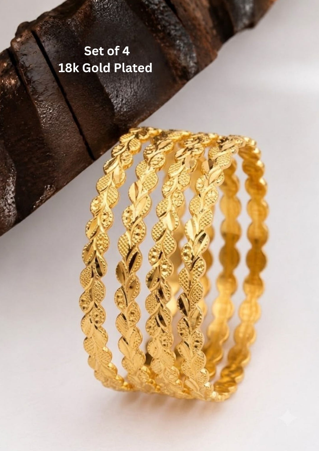 Four slim gold-plated rings stacked together Classic gold plated bangles with intricate engraved detailing for a timeless traditional look.