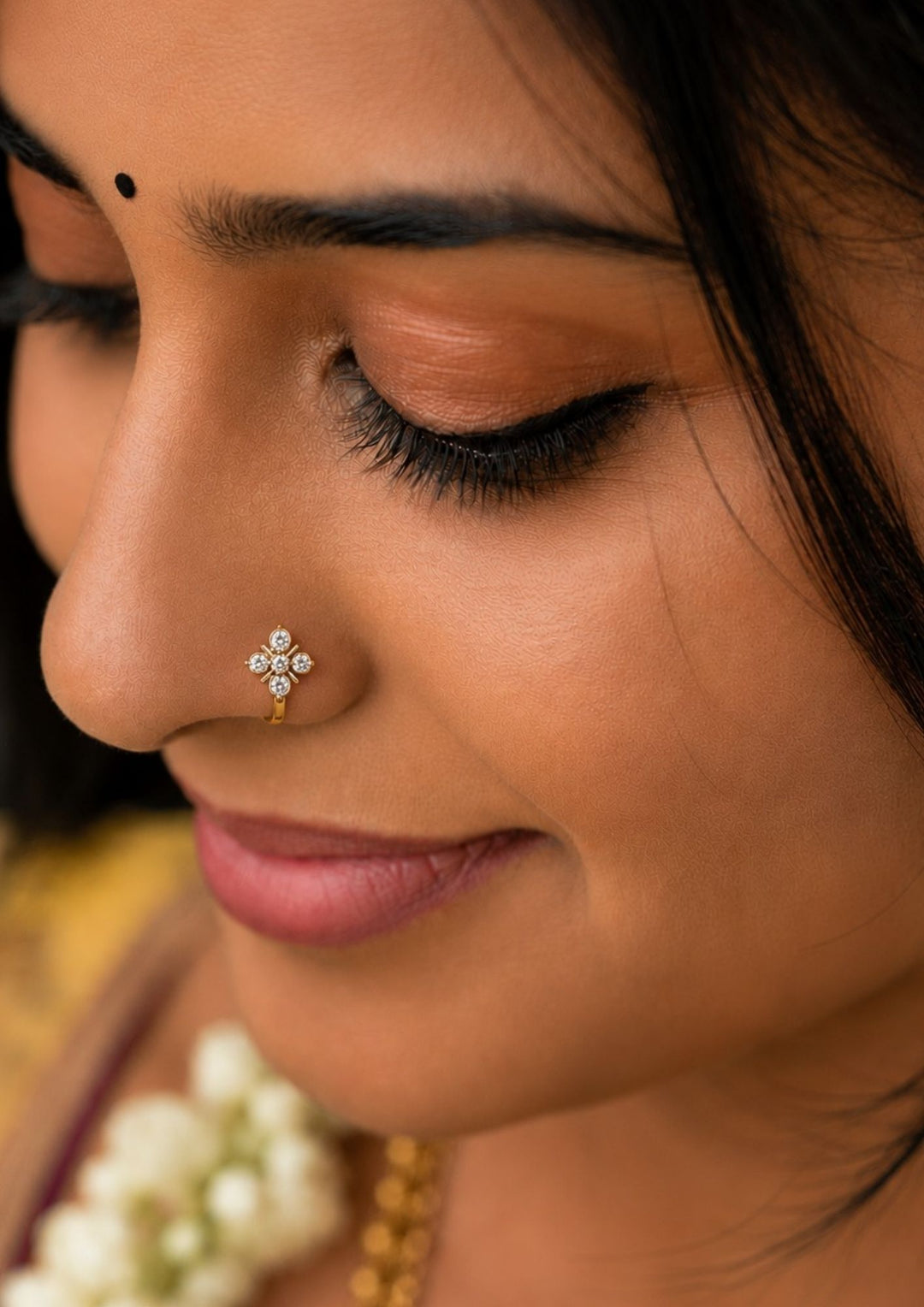 South Indian Women wearing a Gold-plated nose pin design with leaf design using zircon diamonds with back open its perfect for weddings, dailywear and it is antifade color.