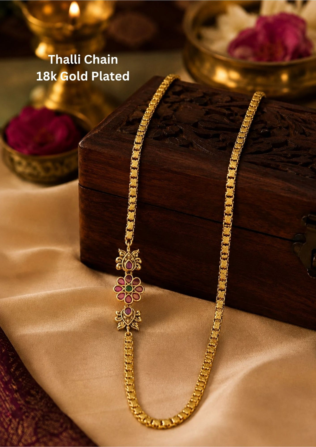 This lightweight 18k gold-plated Mugappu Thali Chain features a durable, woven rope design accented by a sparkling diamond-and-ruby floral side pendant. It is perfect for daily wear, office environments, and casual family gatherings because the high-quality plating resists tarnishing from sweat and everyday use. Additionally, its classic, elegant look makes it an excellent choice for festive occasions, temple visits, and styling with traditional sarees or kurtis.