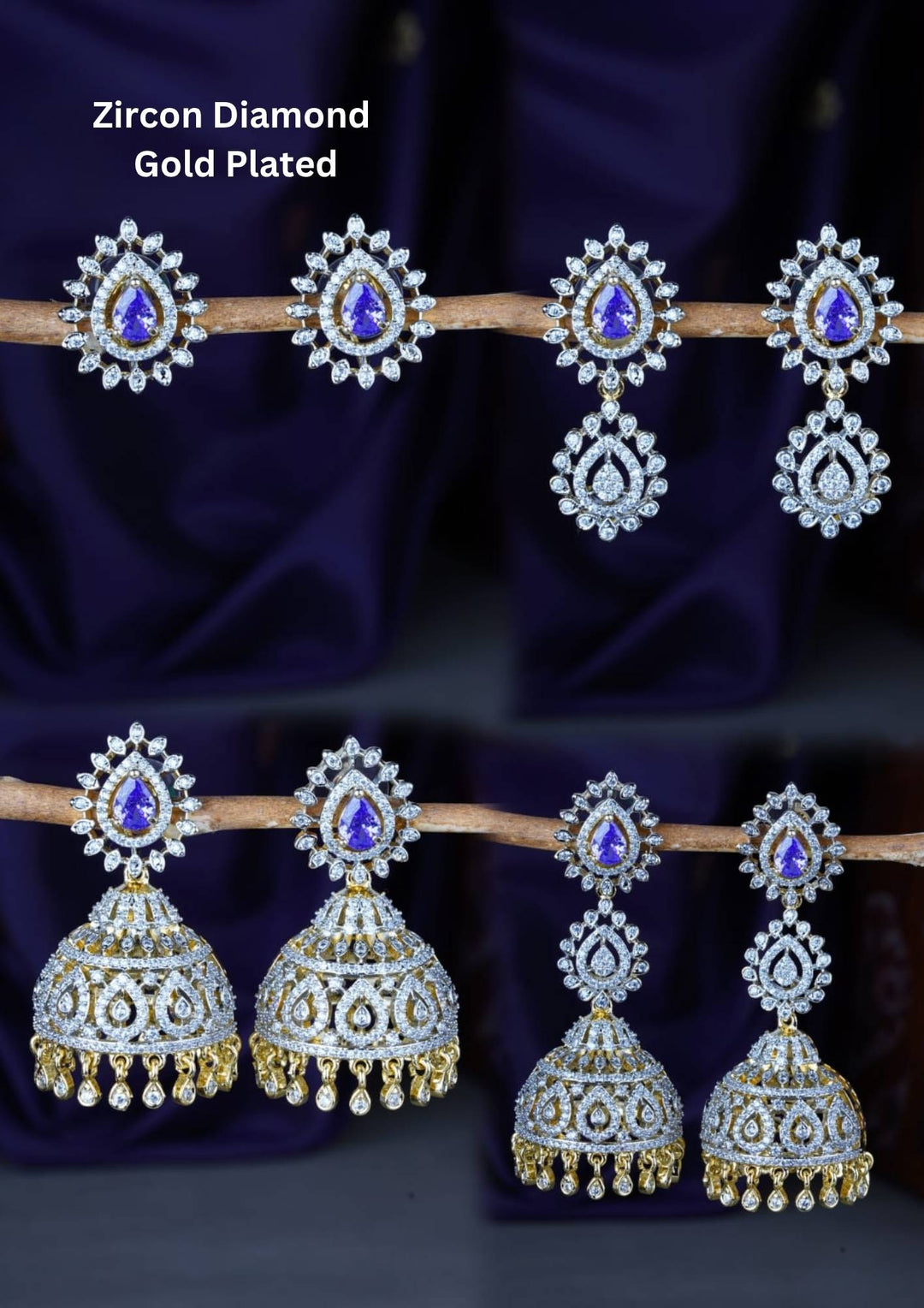 A premium collection of four distinct pairs of gold-plated earrings featuring brilliant white zircon diamonds and vibrant teardrop-shaped emerald blue stones. The assortment includes elegant halo stud earrings, multi-tiered crystal drops, and classic South Indian style hanging jhumkas adorned with intricate stone settings and tiny dangling gold beads, all beautifully arranged on a rustic branch against a deep purple fabric backdrop.