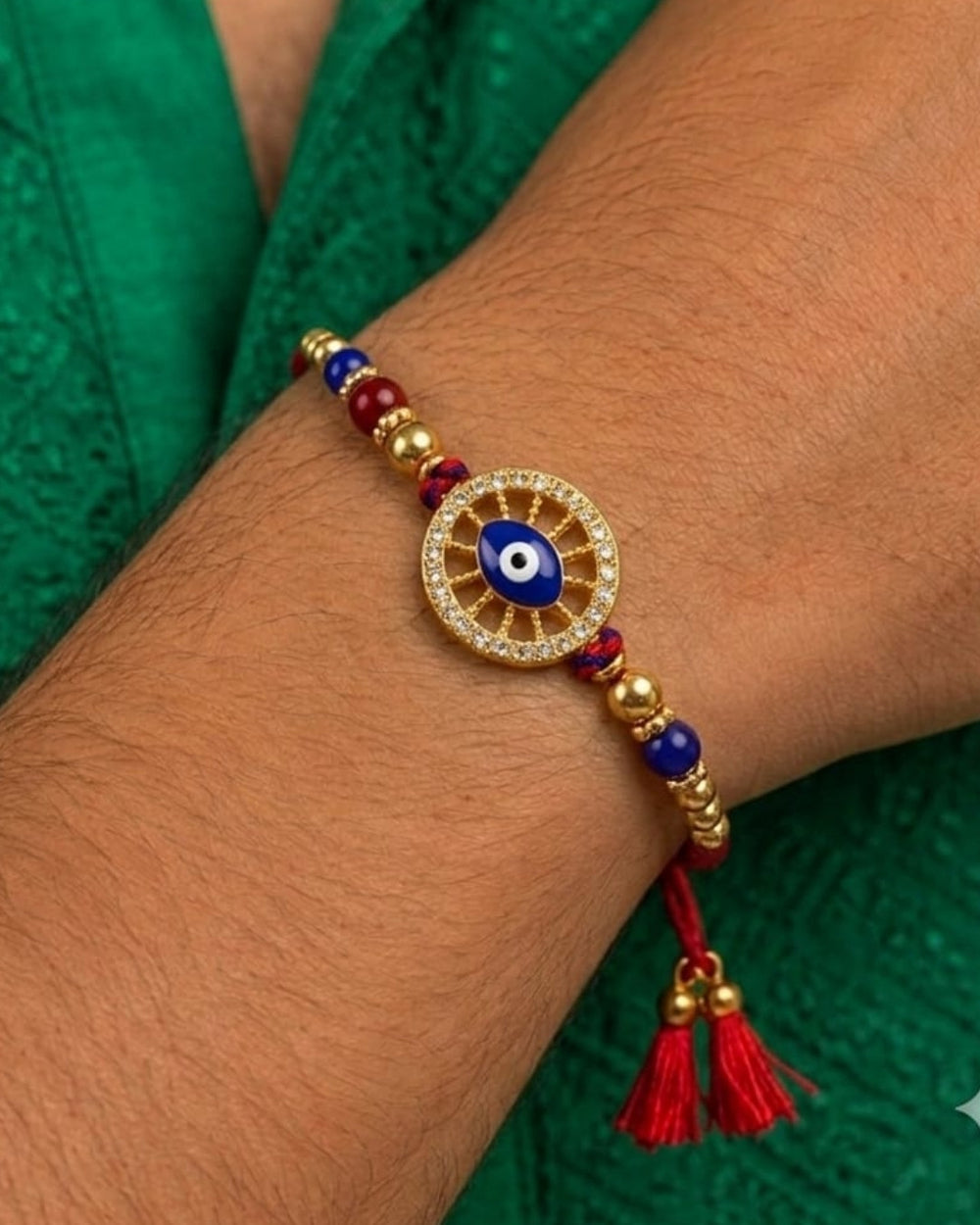 Designer Evil Eye Rakhi gift set featuring matching red and blue thread Rakhis with crystal-studded Evil Eye charms and a stylish adjustable bracelet.