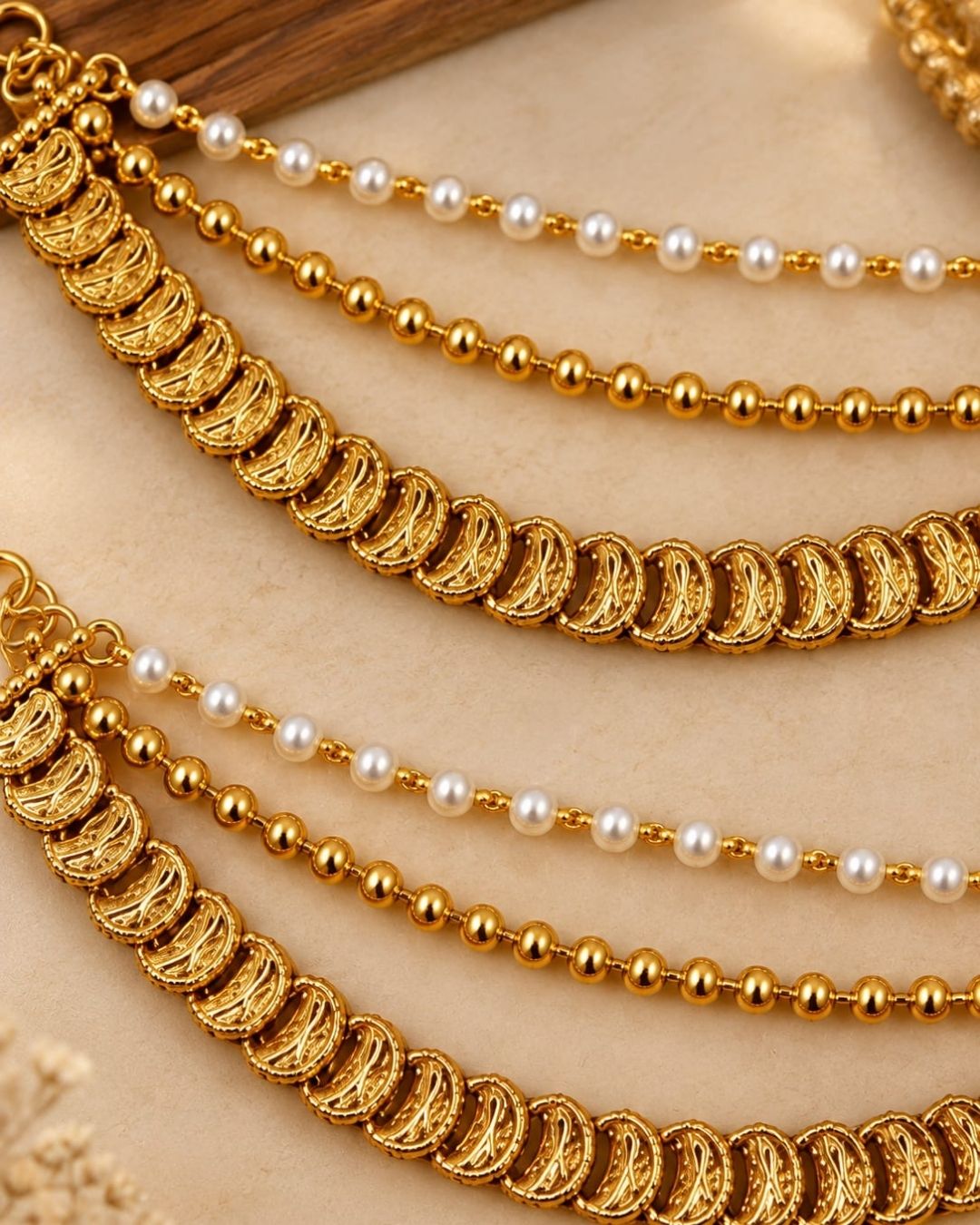 Gold plated traditional ear chains featuring pearl beads, gold ball chains, and intricately detailed antique gold links.