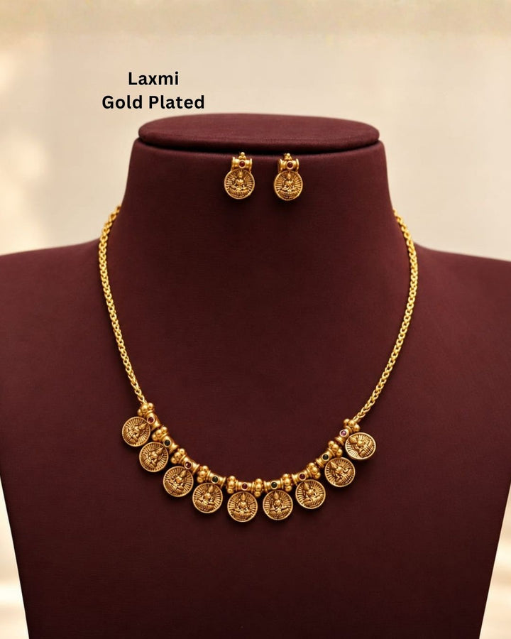 Antique gold plated South Indian coin necklace set with Goddess Lakshmi motifs and matching earrings for festive and traditional wear.