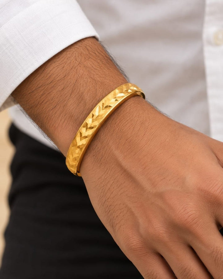 Elegant gold plated men’s kada featuring a broad herringbone patterned band with a polished finish, perfect for traditional and modern wear.