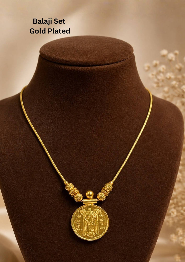 Exquisite God Balaji gold-plated coin necklace featuring intricate motif carvings and ruby-colored stone accents. Ideal for weddings, festive occasions, temple visits, traditional sarees, and bridal gifting.
