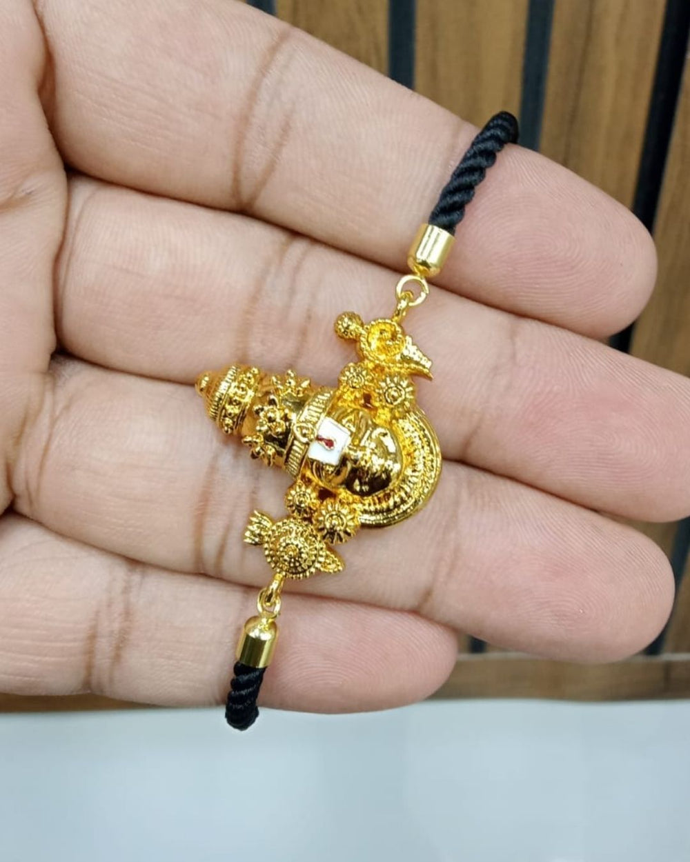 Stylish men's black thread bracelet featuring a detailed Lord Venkateswara gold plated centerpiece, designed for spiritual wear, traditional occasions, daily wear, and gifting.