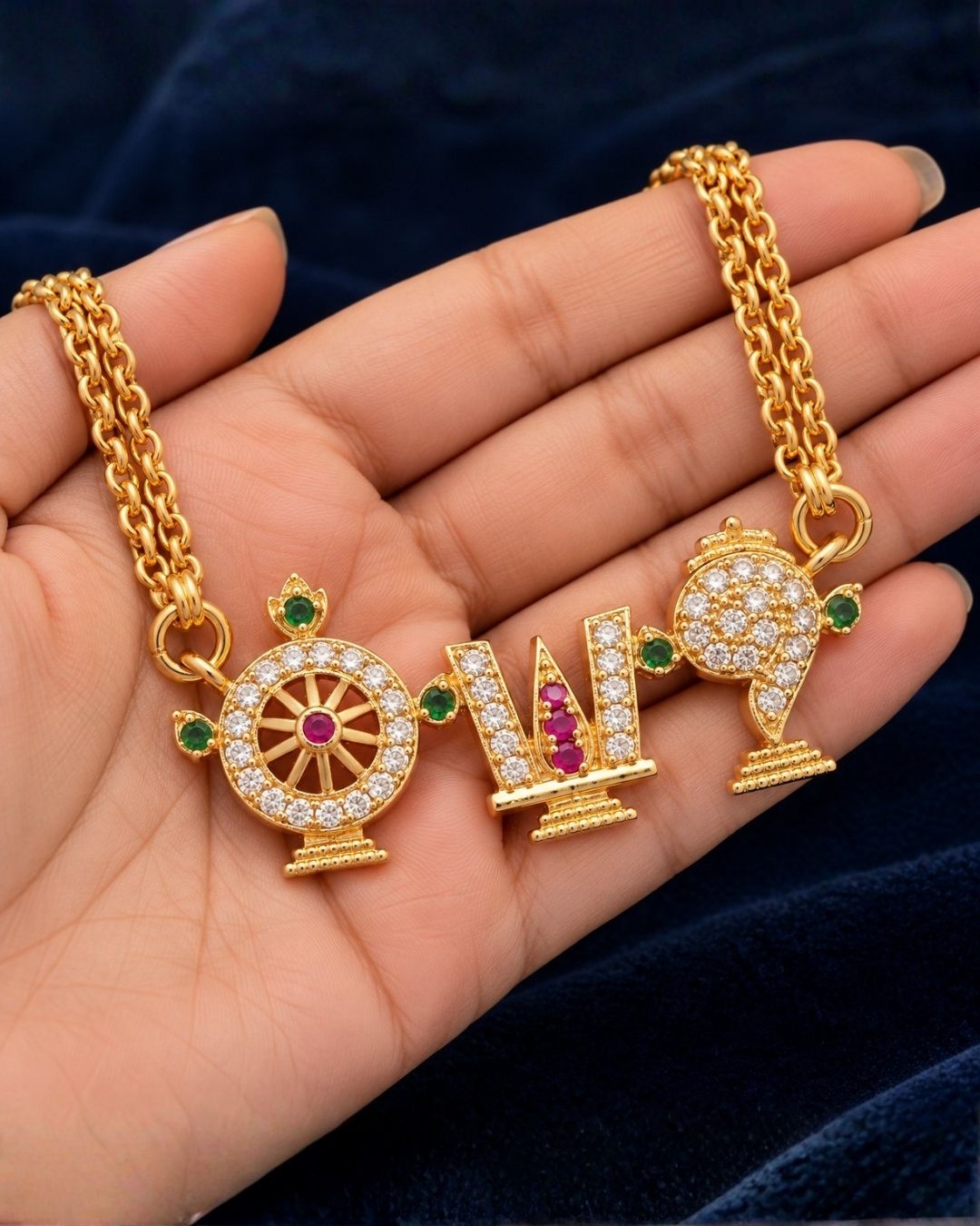 Shanku Chakra Namam 18K gold plated chain necklace designed with white zircon diamonds with vibrant red and green stone highlights on the symbols. It has a premium gold finish, is lightweight, and comfortable to wear. Suitable for daily use, pooja, weddings, festivals, functions, and family occasions. It is sweat-proof, anti-fade, skin-friendly, and easy to wear for long hours.