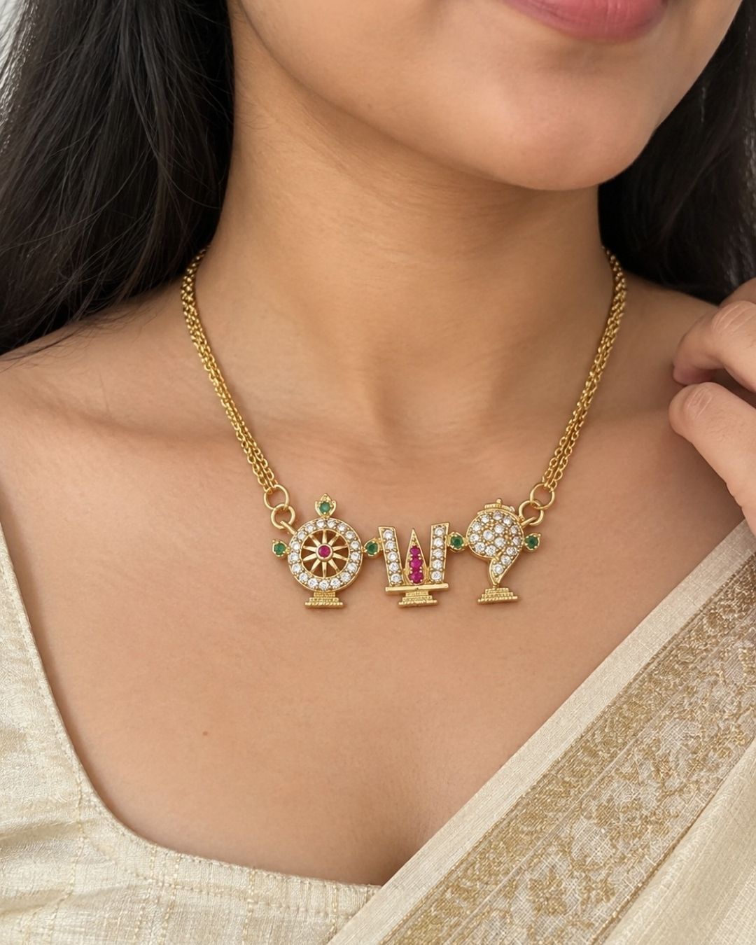 Shanku Chakra Namam 18K gold plated chain necklace designed with white zircon diamonds with vibrant red and green stone highlights on the symbols. It has a premium gold finish, is lightweight, and comfortable to wear. Suitable for daily use, pooja, weddings, festivals, functions, and family occasions. It is sweat-proof, anti-fade, skin-friendly, and easy to wear for long hours.