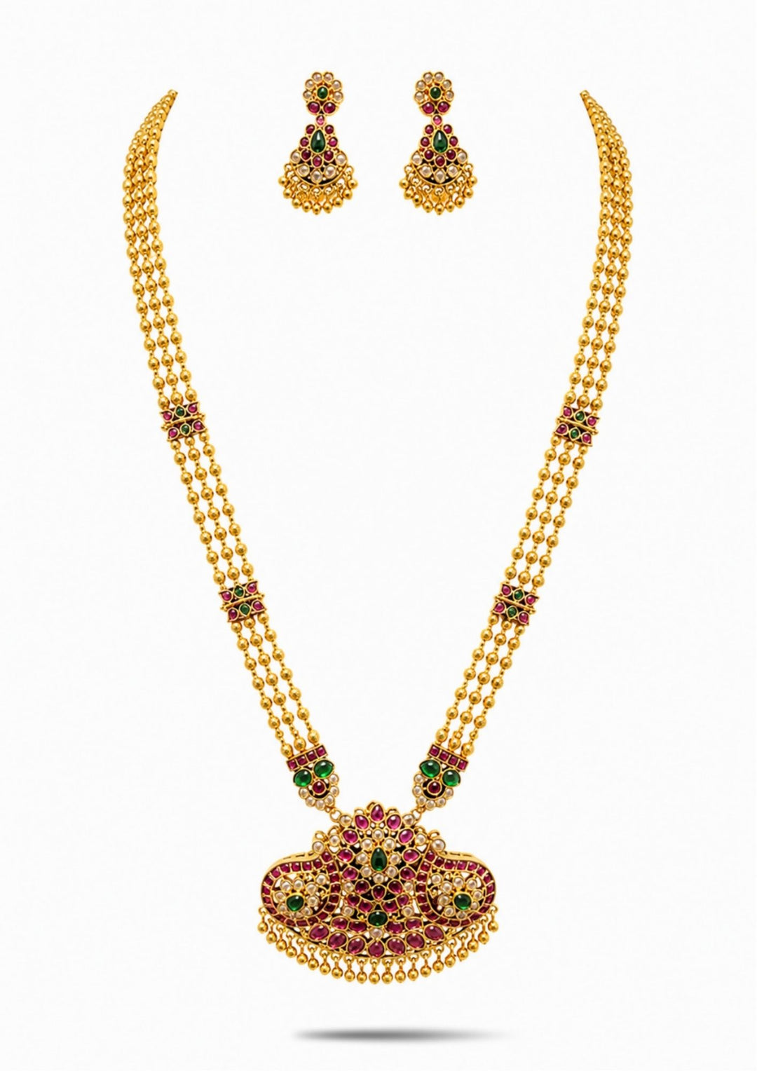 Gold necklace Set with a detailed pendant and earrings  on a white background with green and red stones come with jadau kundan in necklace set with beads and in pendent shows clear design and in detailed shown in picture it will not fade color and water proof can used for festivals, bridals, and weeding's  