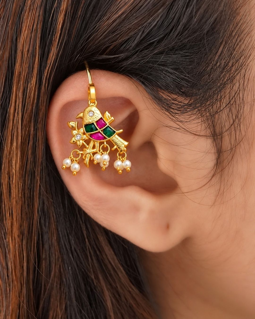 Premium gold plated bugadi earrings featuring an ornate traditional design embellished with green and pink stones, sparkling clear accents, floral detailing, and delicate pearl drops. Perfect for weddings, festive occasions, traditional wear, parties, and gifting.