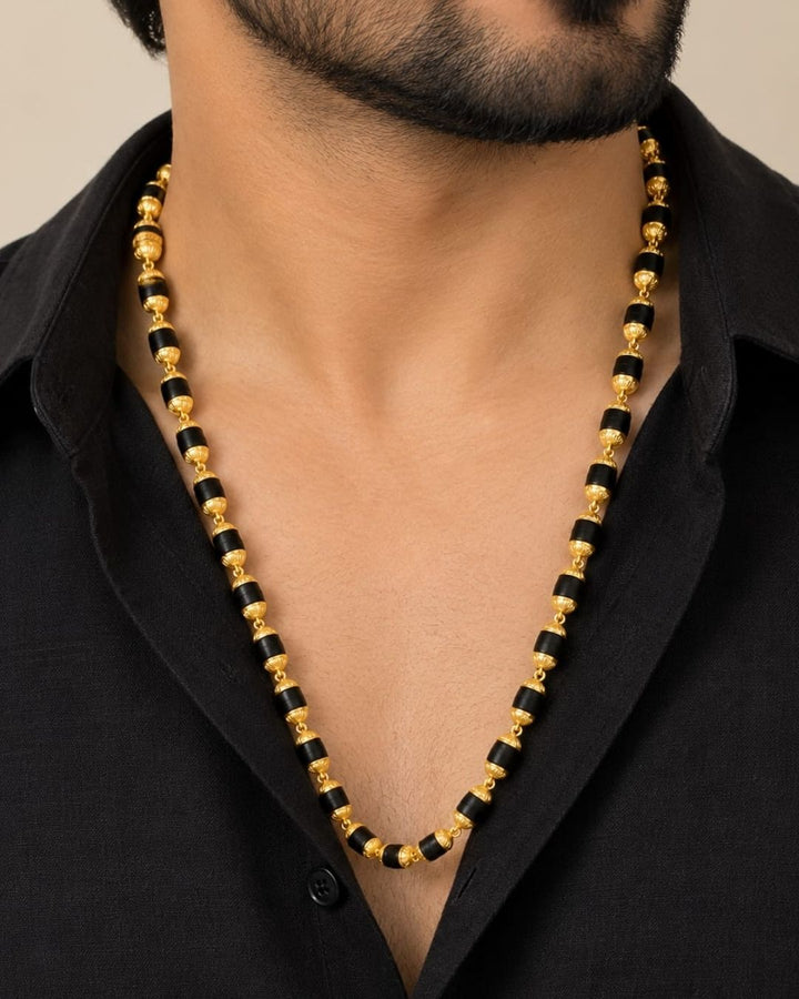 Elegant gold plated men’s Rudraksha mala featuring alternating black beads and detailed gold accents, designed for a traditional and spiritual look.