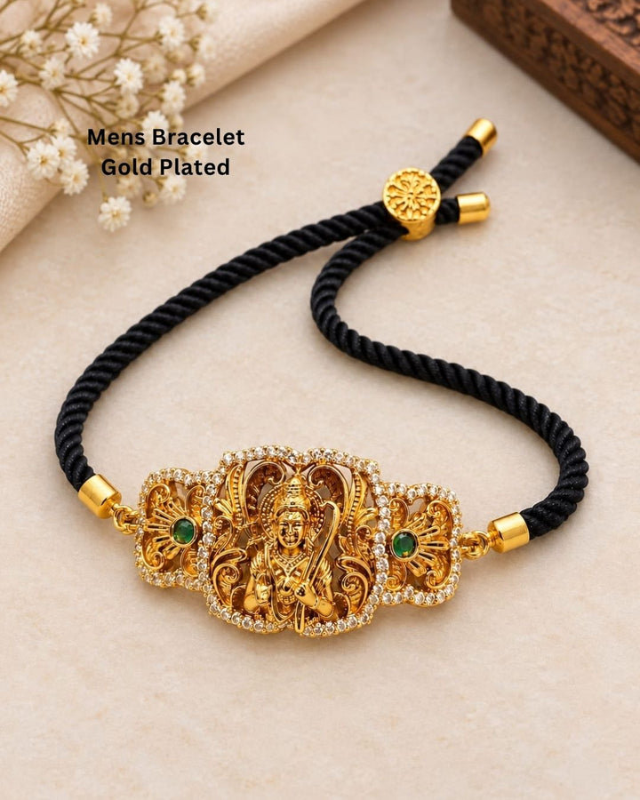 Traditional gold plated men’s bracelet featuring an intricately detailed Lord Hanuman centerpiece, black twisted thread band, sparkling stone borders, green stone accents, and adjustable detailing, perfect for spiritual, traditional, and everyday wear.