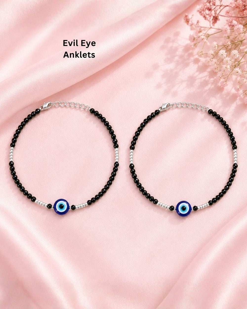Beautiful set of two black beaded evil eye bracelets featuring faceted black beads, silver bead accents, and blue evil eye centerpiece charms. Perfect for daily wear, casual outfits, gifting, and stylish occasions.