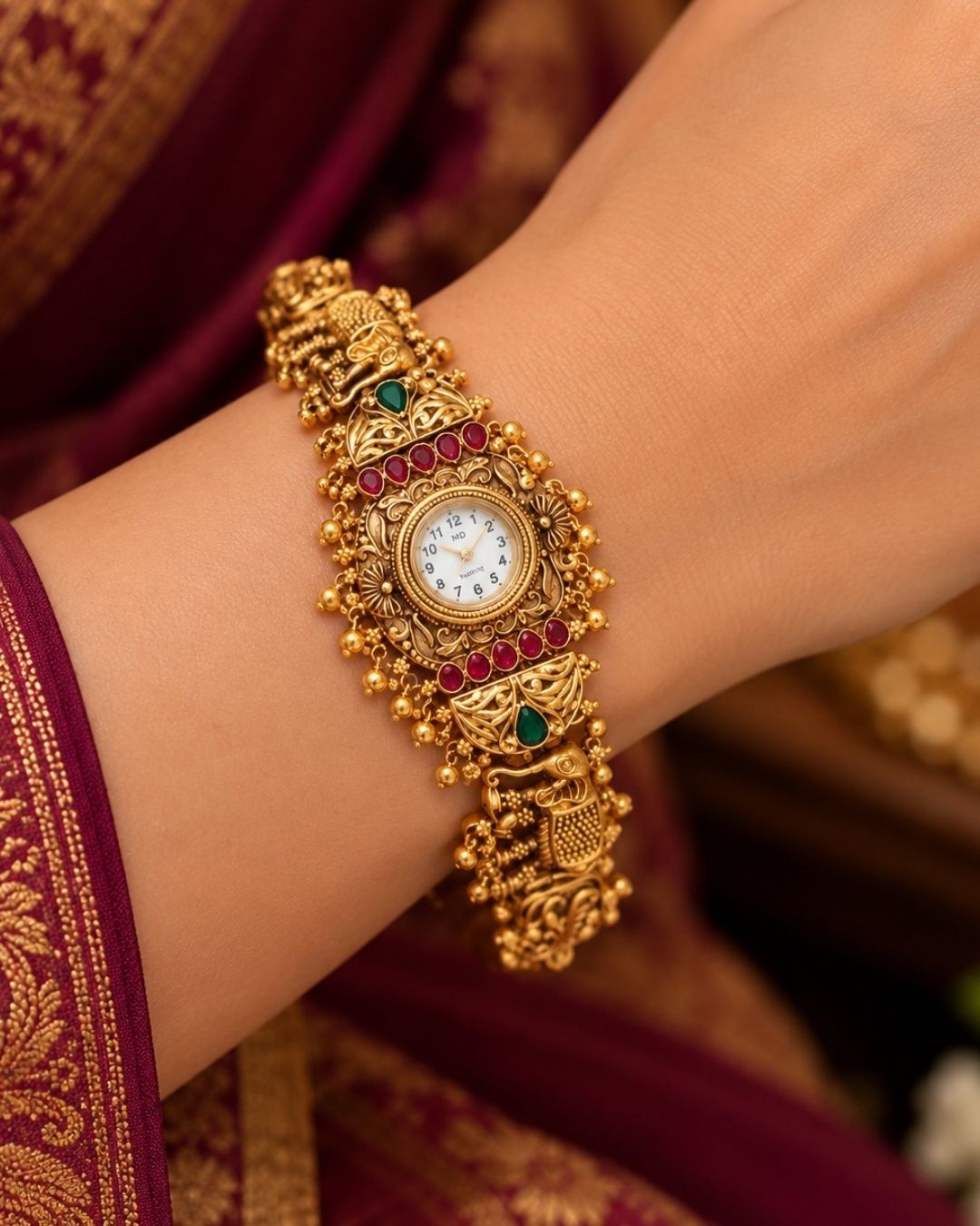 Antique gold plated bracelet watch displayed diagonally on cream fabric and a wooden surface with delicate floral accents.
