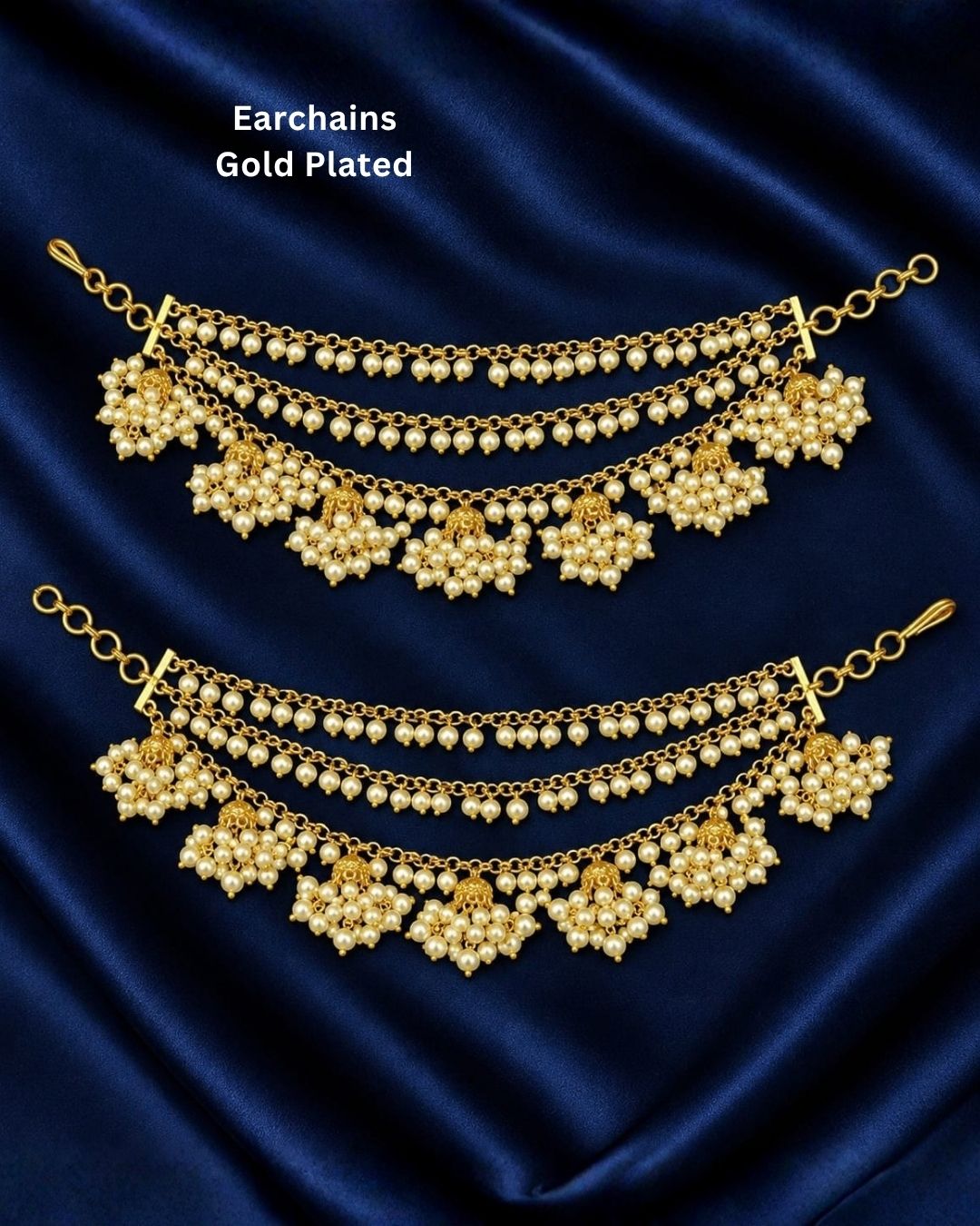 Traditional gold plated pearl ear chains featuring three layered chains with clusters of white pearls and intricate gold motifs, perfect for bridal and festive occasions.
