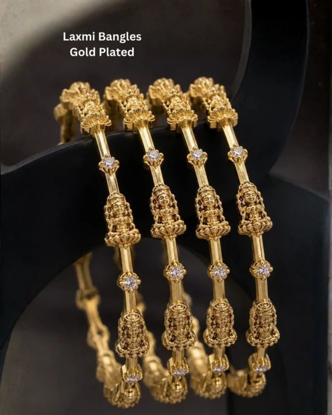 Elegant Lakshmi gold plated bangles featuring finely sculpted Goddess Lakshmi motifs with sparkling zircon stones. Ideal for weddings and traditional occasions.