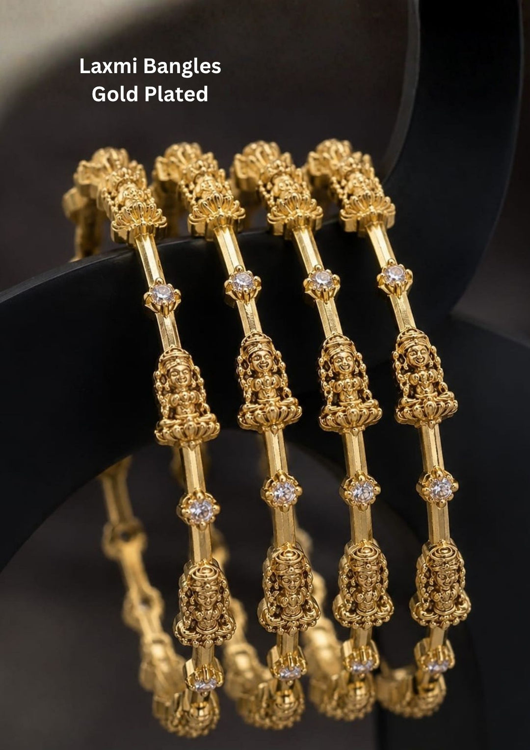 Elegant Lakshmi gold plated bangles featuring finely sculpted Goddess Lakshmi motifs with sparkling zircon stones. Ideal for weddings and traditional occasions.