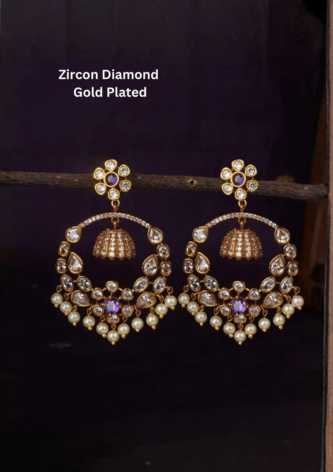 Zircon diamond gold plated blue Chandbali Long Earrings with hanging guttapusalu design, sparkling white zircon stones, floral pattern detailing, and elegant layered arrangement finished with shiny gold plating. The earrings come with lightweight, sweat proof quality, anti-fade colour, skin-friendly finish, and are suitable for weddings, receptions, festivals, functions, and party wear .