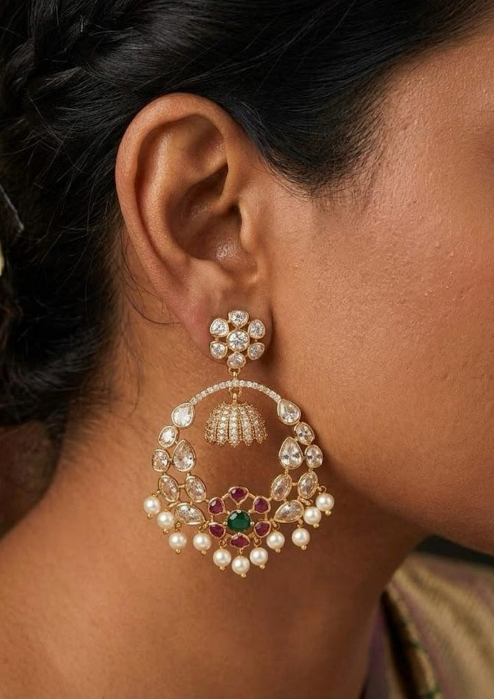 Close-up of an ear wearing Chandbali multi colour earring Zircon diamond gold plated red and green multi colour Chandbali Earrings. The earrings show sparkling stone detailing with lightweight comfort, sweat proof finish, anti-fade colour, smooth fitting, and are perfect for receptions, parties, weddings, and traditional functions.