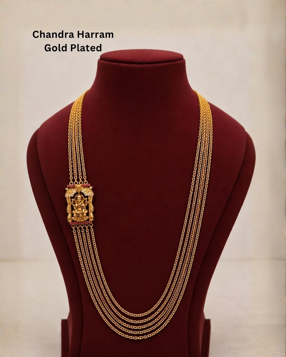 Beautiful traditional gold plated necklace featuring multiple layered chains and a detailed goddess pendant with red and green accents. Perfect for festive occasions, traditional outfits, weddings, parties, and gifting.