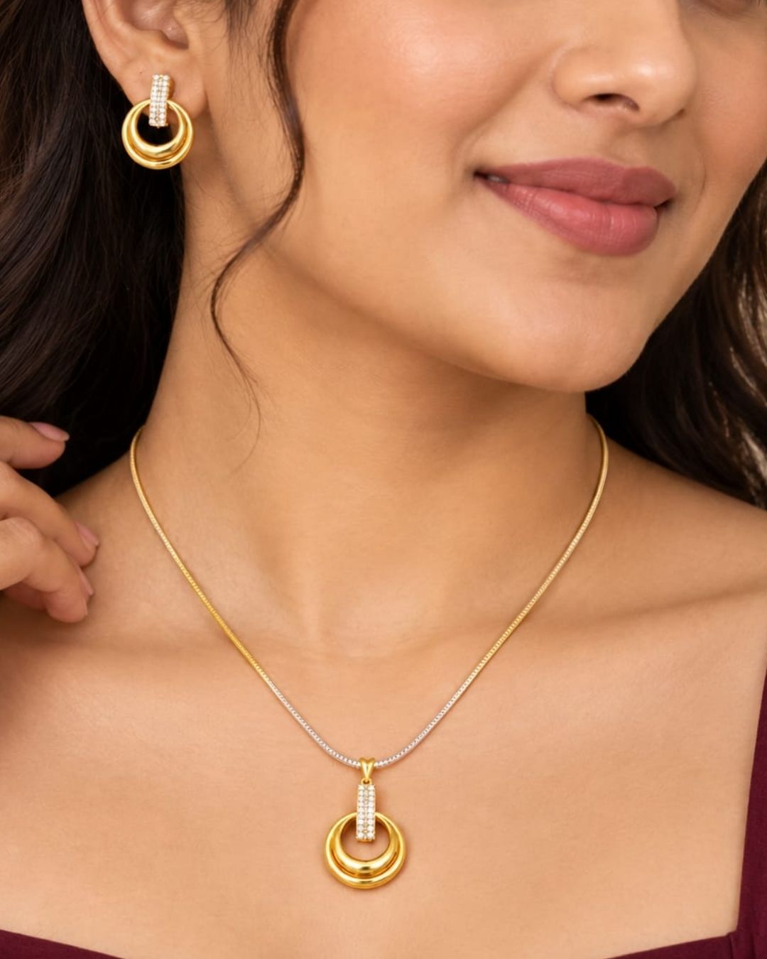 Stylish gold plated necklace set featuring a delicate chain, circular pendant with sparkling stone-studded detailing, and matching circular earrings, perfect for festive, party, and traditional occasions.