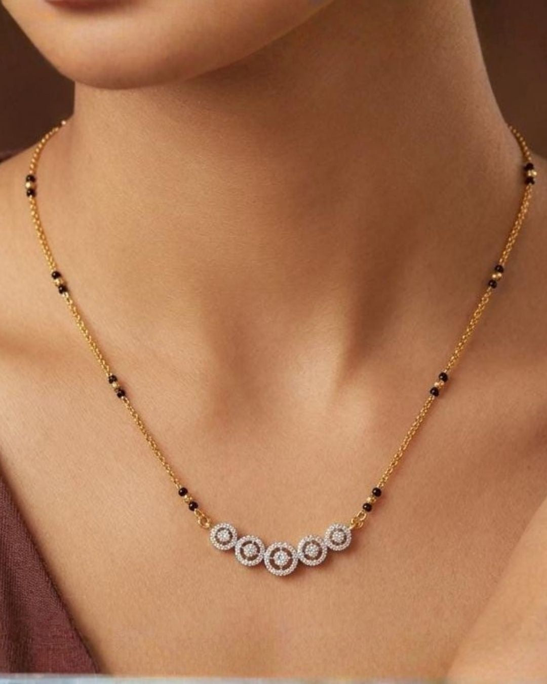 South indian women's Traditional gold plated mangalsutra necklace with black beads and five shimmering CZ circle accents, ideal for daily and festive wear.
