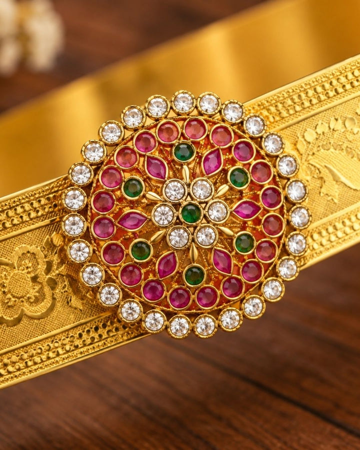 Beautiful gold plated designer hip belt featuring pink, green, and white stone accents with a removable floral pendant. Suitable for kids and adults, perfect for traditional outfits, festive occasions, dance performances, weddings, and special events.