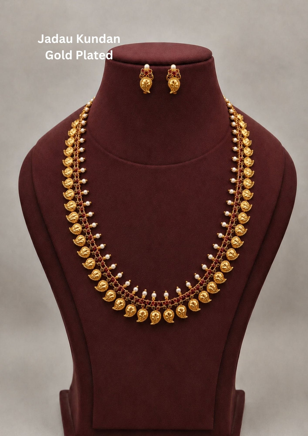 Gold plated long temple necklace and matching earrings set featuring a continuous line of traditional round gold coins stamped with deity images, bordered by neat mango-shaped (paisley) gold motifs along the edge. The design creates a heavy, layered look that hangs gracefully, making it a perfect classic choice for weddings, festivals, and traditional family functions.