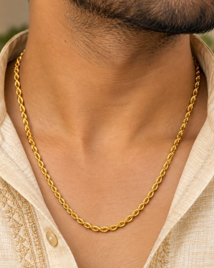 Gold plated men’s chain displayed in hand, highlighting its twisted links and shiny finish.
