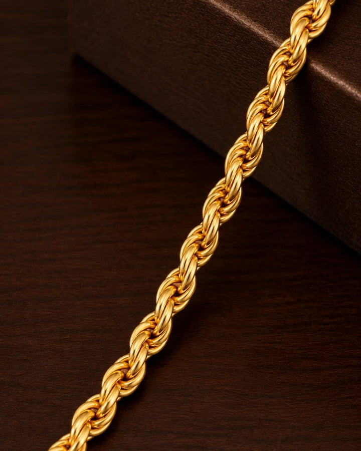 Gold plated men’s chain displayed in hand, highlighting its twisted links and shiny finish.