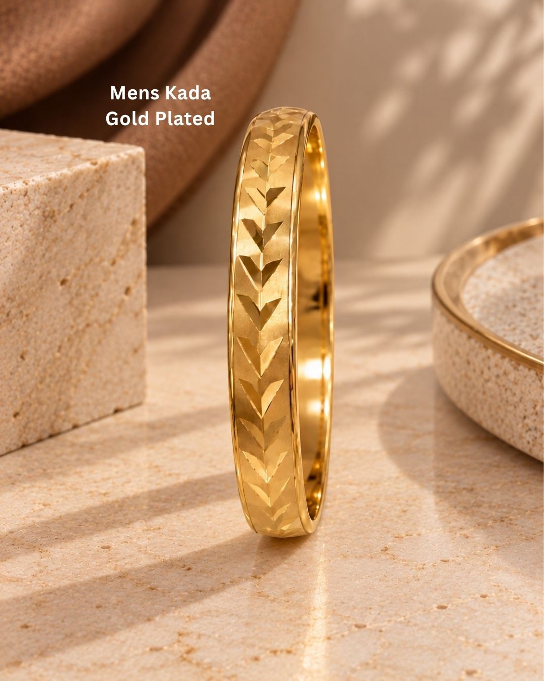 Elegant gold plated men’s kada featuring a broad herringbone patterned band with a polished finish, perfect for traditional and modern wear.