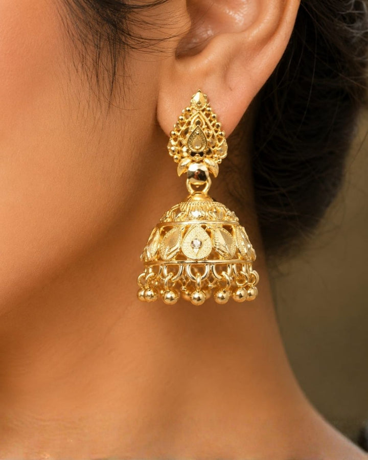 Premium gold plated traditional jhumka earrings featuring intricate ethnic craftsmanship, ornate dome-shaped designs, floral detailing, and elegant hanging gold bead accents. Perfect for sarees, festive occasions, weddings, classical dance performances, and traditional events.