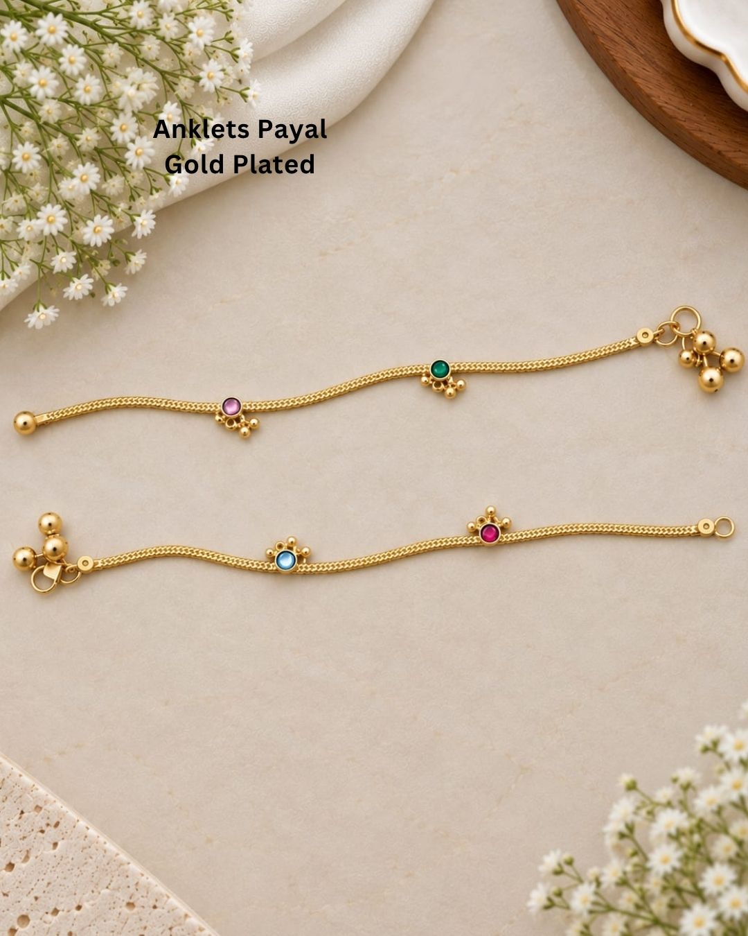 Beautiful gold plated payals featuring delicate chain patterns with pink, green, and blue stone embellishments and charming hanging bead details. Perfect for traditional wear, festive occasions, weddings, daily wear, and gifting.