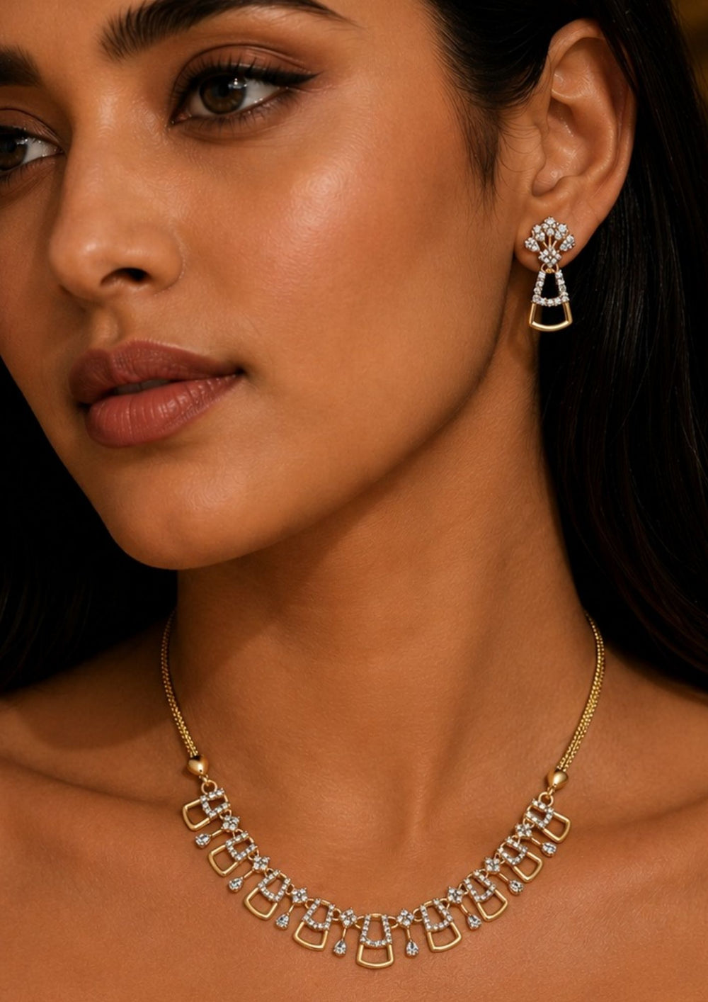 South Indian woman styling a zircon diamond gold plated geometric necklace set with matching earrings. The jewelry features brilliant diamond-look zircon stones, sleek openwork patterns and a lightweight elegant finish that beautifully complements sarees, gowns, lehengas and modern ethnic outfits.