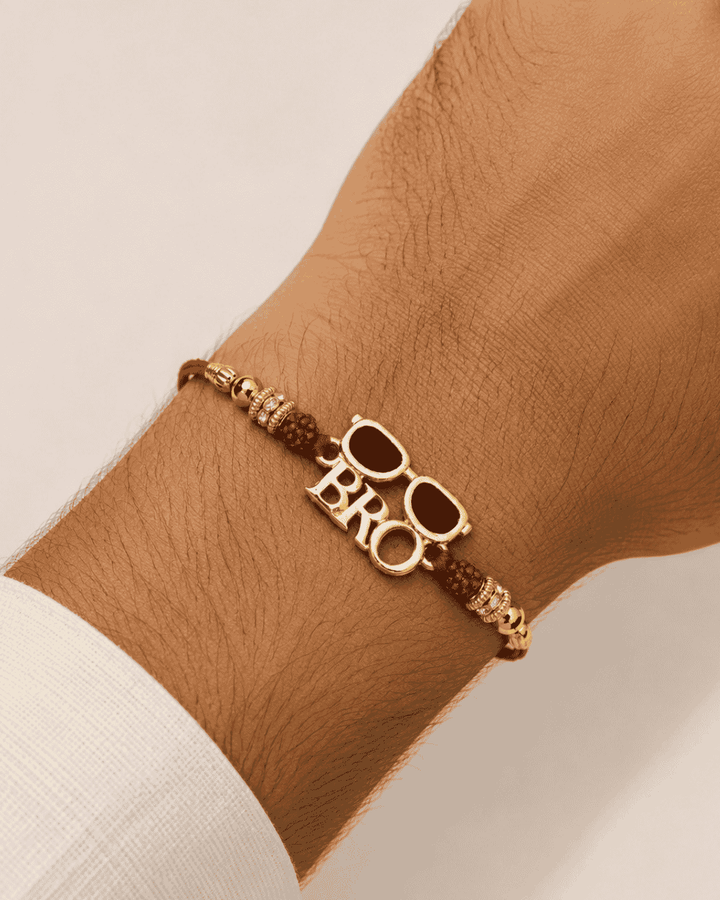 Premium BRO Rakhi showcasing a fashionable sunglasses-inspired design with gold-tone beads, red accents, and an elegant handcrafted finish.