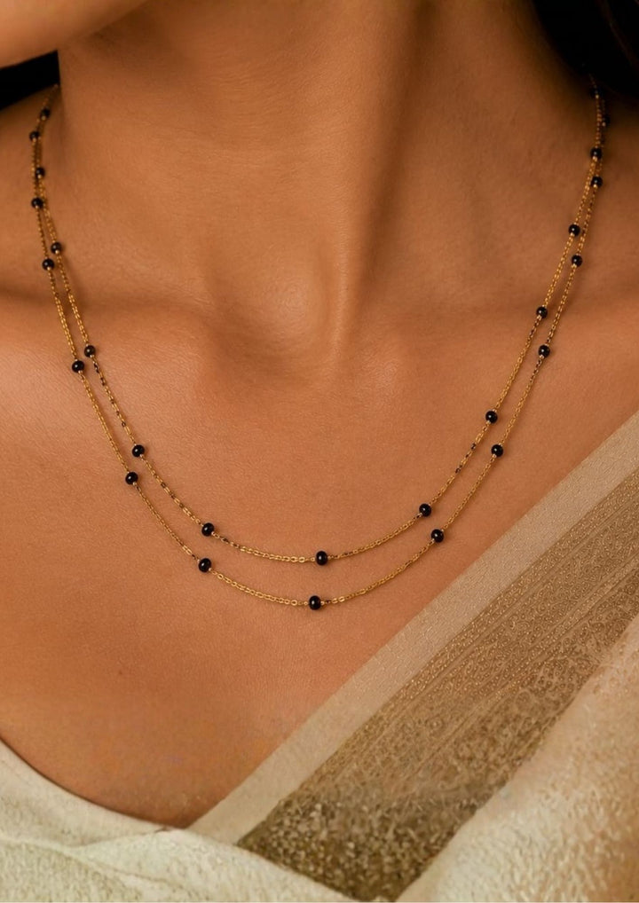 Beautiful 18K gold plated double layer black beads mangalsutra chain featuring a sleek minimalist design and elegant craftsmanship. Perfect for daily wear, office wear, festive occasions, traditional outfits, and premium gifting.