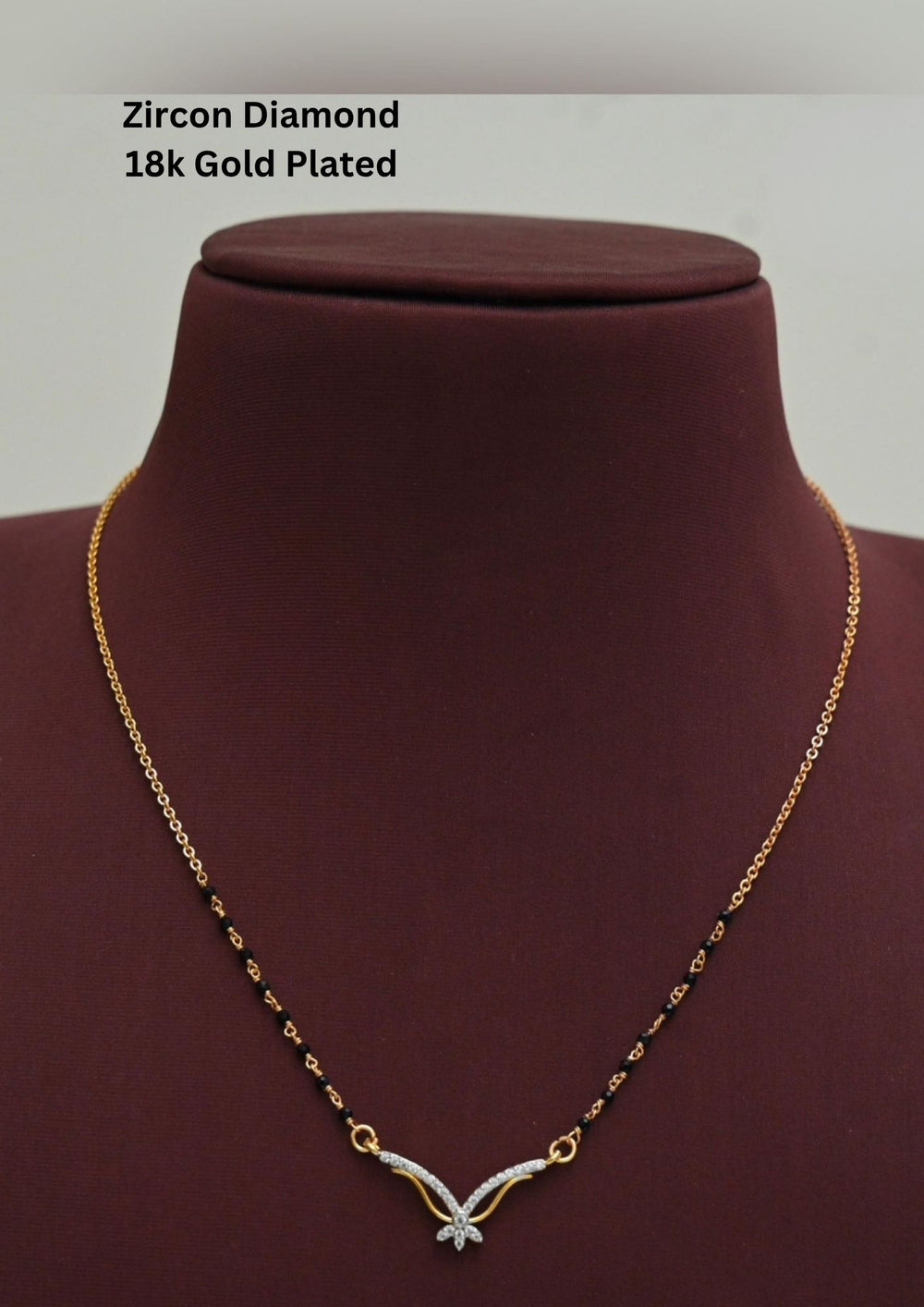 Gold plated black beads mangalsutra featuring an elegant butterfly-inspired zircon centerpiece with delicate curved detailing. Lightweight and beautifully crafted for everyday elegance, festive occasions, and gifting.