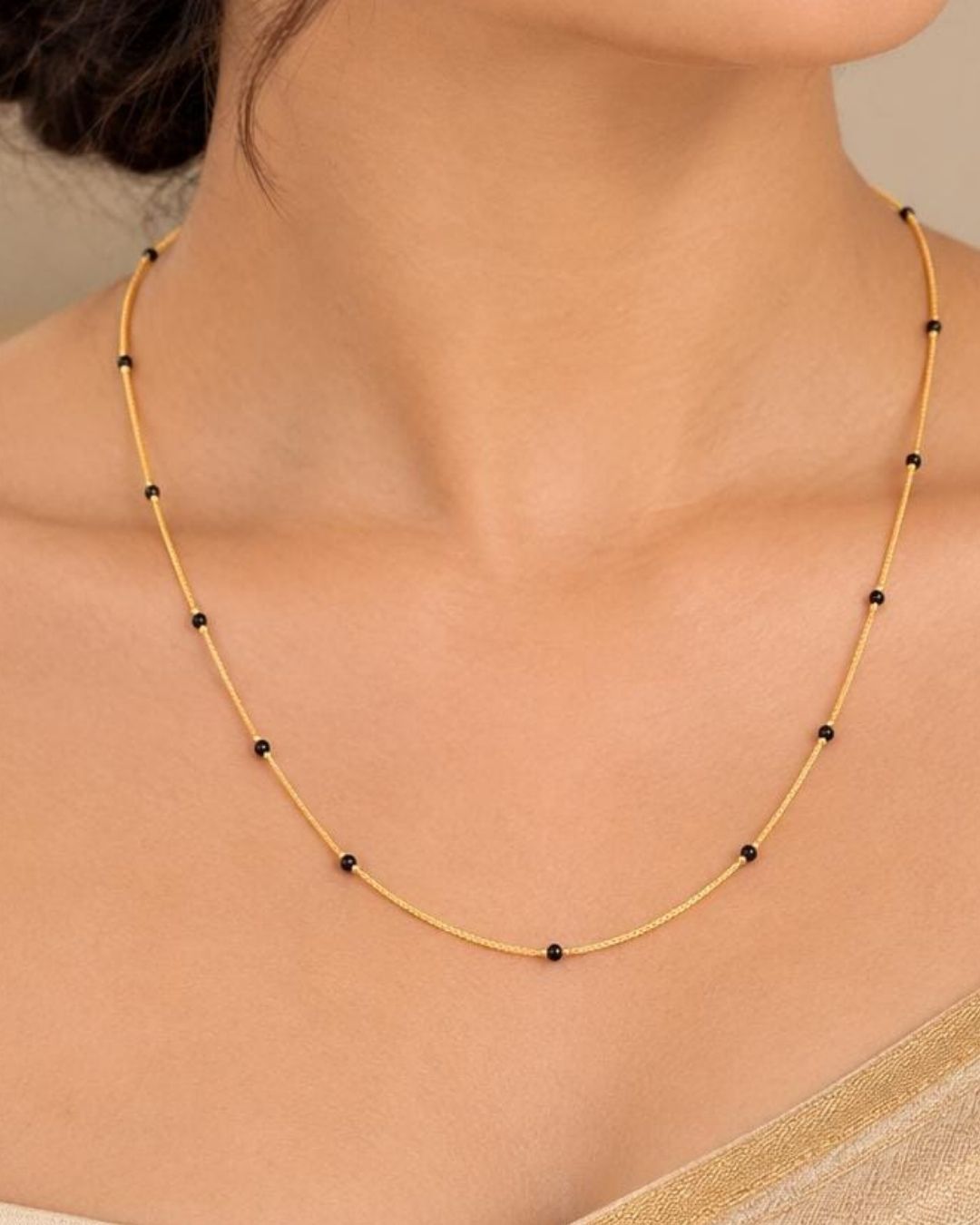 Beautiful simple Mangalsutra featuring a delicate gold plated chain with classic black beads. Perfect for daily wear, office wear, traditional outfits, festive occasions, and gifting.