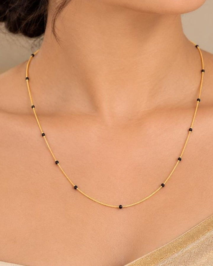 Beautiful simple Mangalsutra featuring a delicate gold plated chain with classic black beads. Perfect for daily wear, office wear, traditional outfits, festive occasions, and gifting.