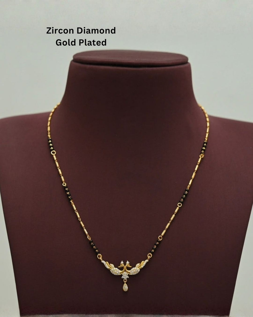 Traditional gold plated mangalsutra featuring black beads, detailed gold accents, a sparkling CZ pendant, and a delicate teardrop embellishment, perfect for everyday and festive wear.