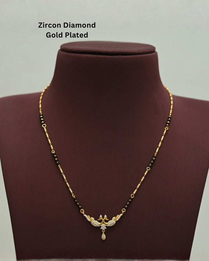 Traditional gold plated mangalsutra featuring black beads, detailed gold accents, a sparkling CZ pendant, and a delicate teardrop embellishment, perfect for everyday and festive wear.