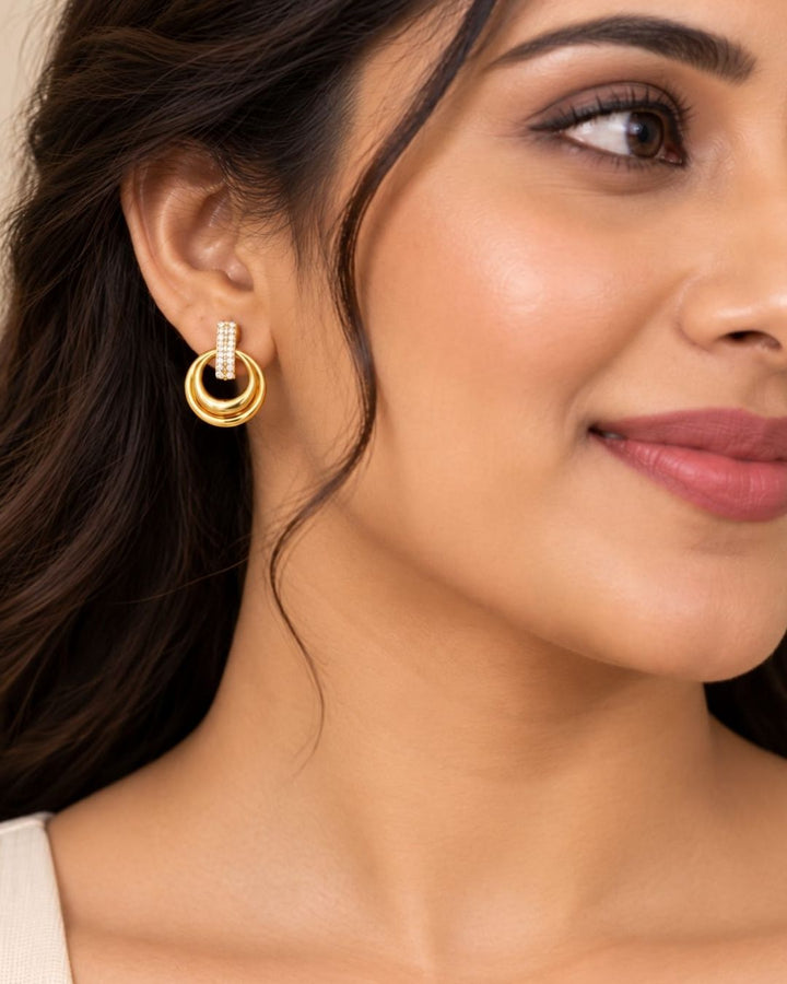 Stylish gold plated necklace set featuring a delicate chain, circular pendant with sparkling stone-studded detailing, and matching circular earrings, perfect for festive, party, and traditional occasions.