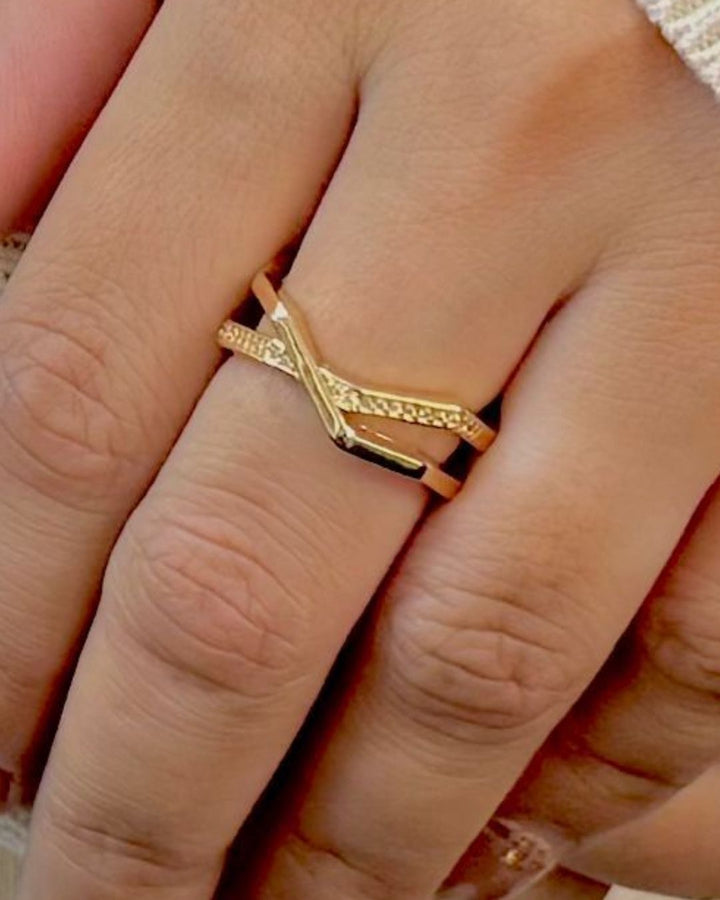 Stylish gold plated adjustable ring featuring an elegant criss cross design, sparkling stone accents, polished finish, and open adjustable band, perfect for daily wear, special occasions, and modern styling.