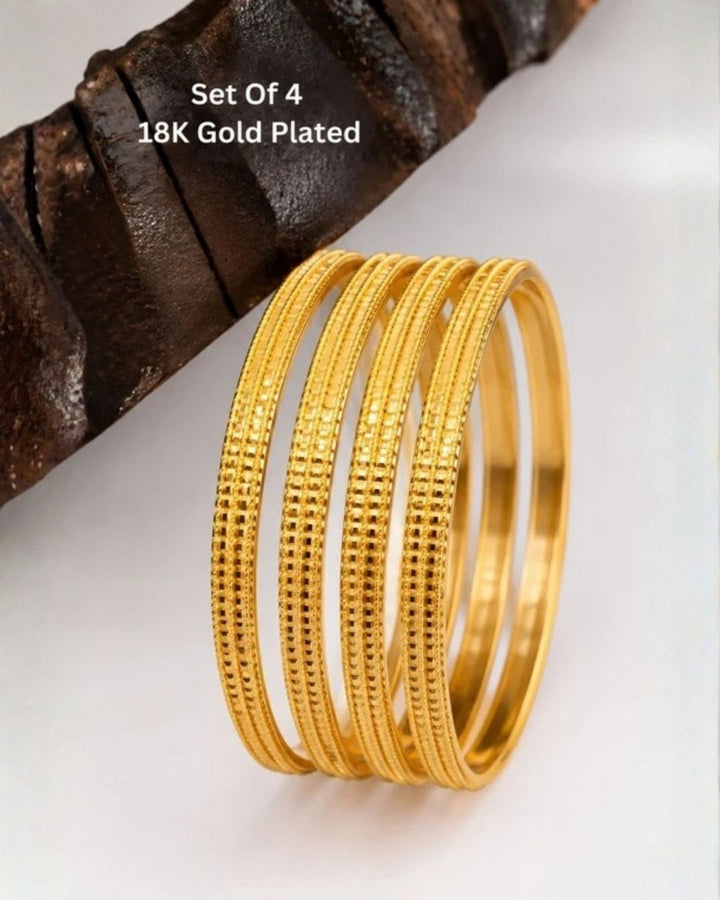 Premium set of four 18K gold plated bangles featuring beautifully engraved geometric patterns.
Designed for lightweight comfort and long-lasting shine.
Perfect for festive celebrations, weddings, office wear, and gifting.