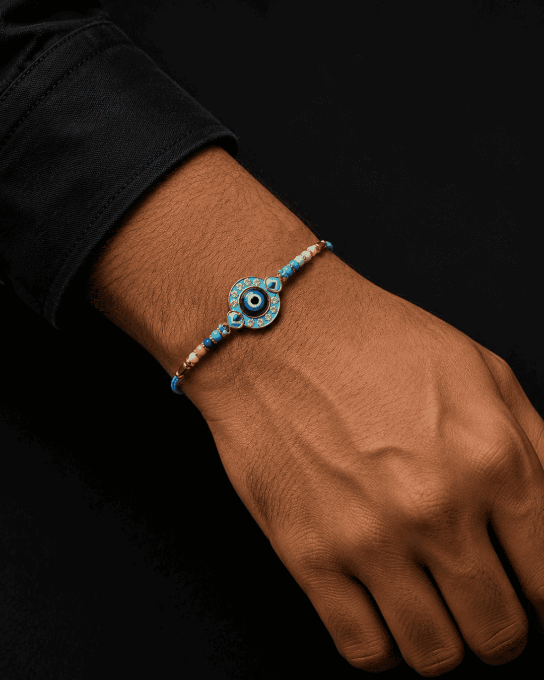 Premium Evil Eye Designer Rakhi with a blue enamel evil eye centerpiece, beaded accents, and durable thread, perfect for Raksha Bandhan gifting.