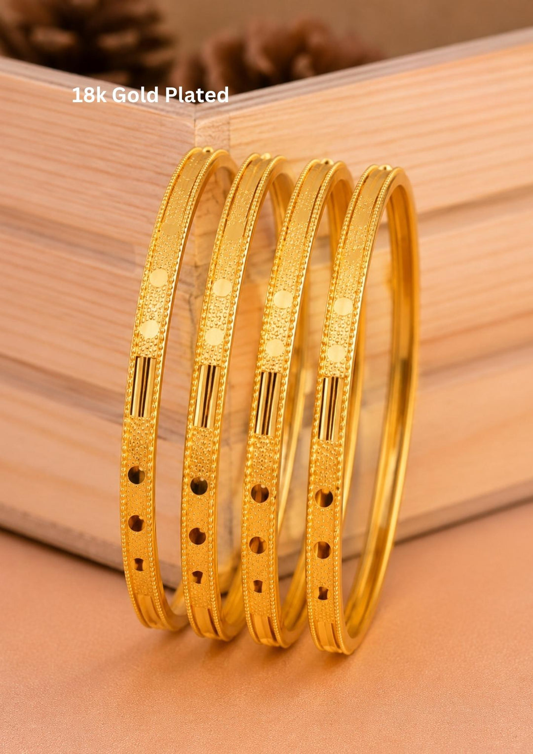 Elegant set of four 18K gold plated bangles designed with fine textured detailing and polished accents.
Lightweight, comfortable, and suitable for everyday elegance.
Perfect for office wear, festive occasions, weddings, and gifting.