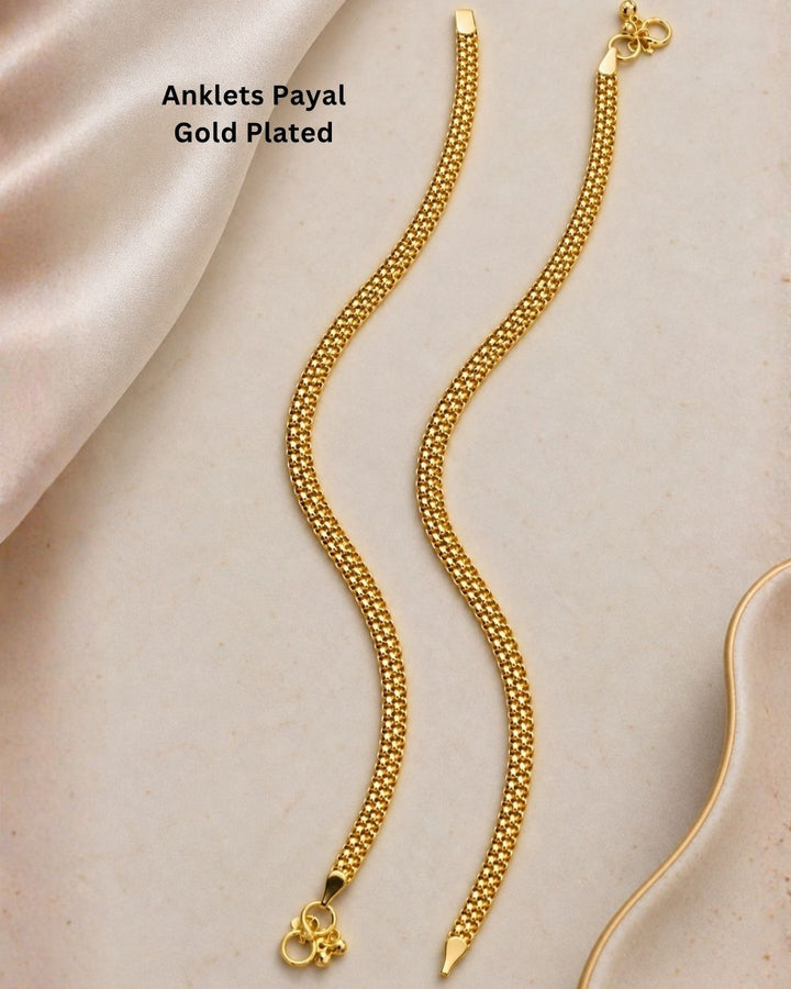 Beautiful gold plated payals featuring a detailed mesh chain design with delicate traditional bell charms and secure clasp detailing. Perfect for traditional wear, festive occasions, weddings, daily wear, and gifting.